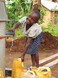 Child drawing water from a tap