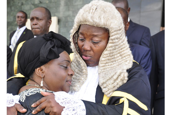 Speaker Rebecca Kadaga comforts Gender minister Mary Karooro Okurut at Parliament yesterday. This was during a special session to honour the minister’s late husband Stanislaus Okurut. PHOTO BY GEOFFREY SSERUYANGE