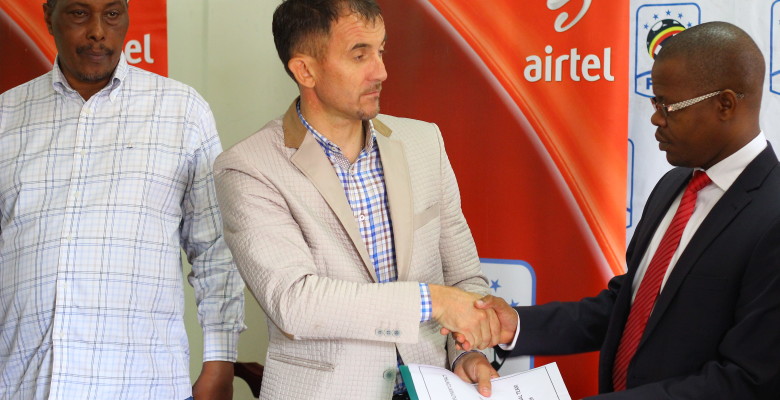 Micho with FUFA president after signing the contract in Mengo