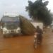 PHOTOS: Truck driver fails to negotiate pothole, stuck on road