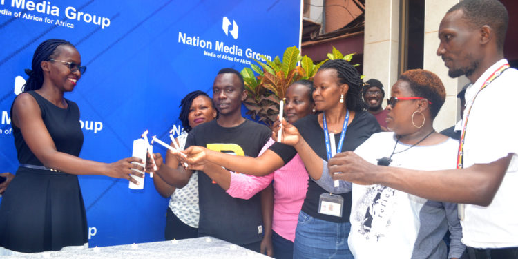 NMG-U staff commemorate International AIDS Candlelight Memorial