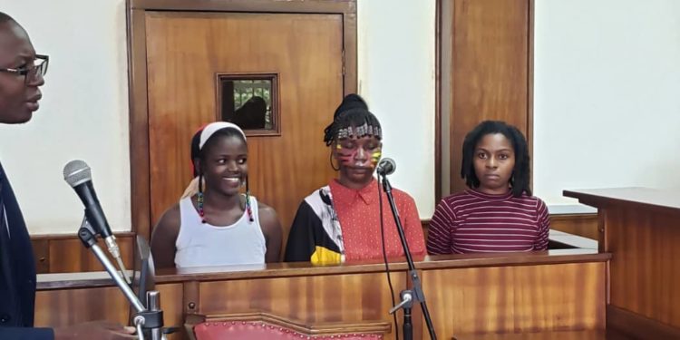 Three women remanded over nude protest